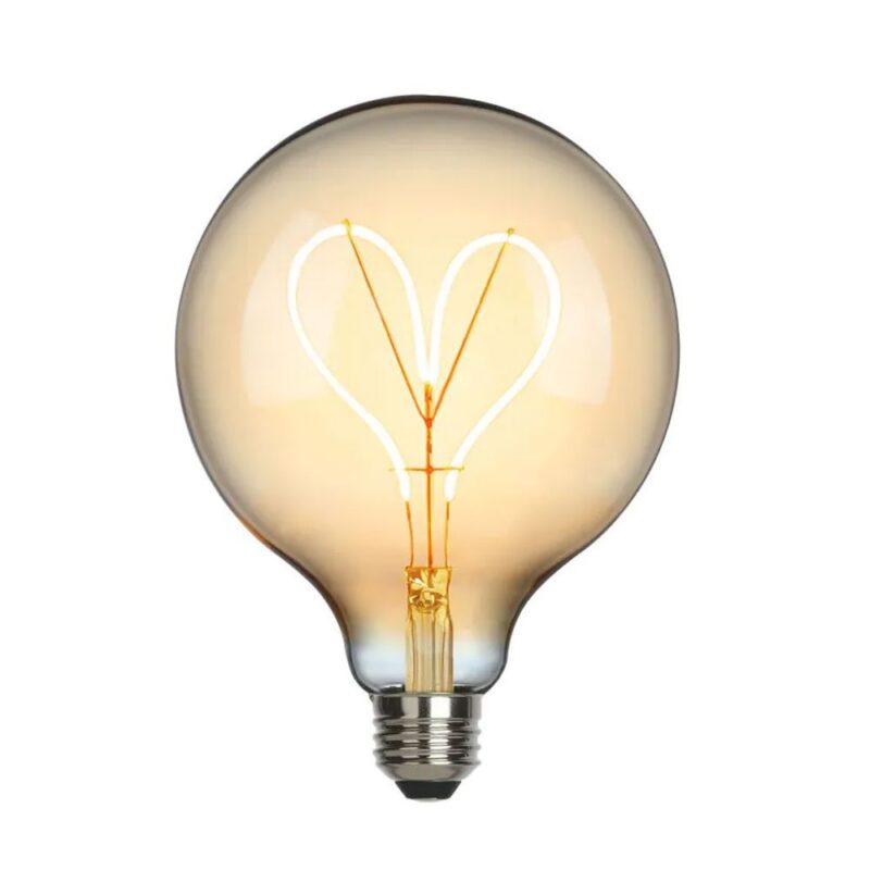 Die Statement-Glühbirne „Love Gold“ verfügt über einen herzförmigen Glühfaden in rundem Design und strahlt ein warmes, bernsteinfarbenes Licht aus, das die komplizierten Details vor einem weißen Hintergrund wunderschön hervorhebt.