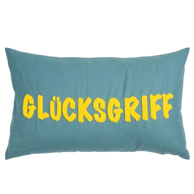 Auf einem rechteckigen, blaugrünen Kissen mit der Bezeichnung „Kissenbezug – Glück“ ist in der Mitte der Schriftzug „GLÜCKSGRIFF“ in großen, gelben Buchstaben aufgestickt.