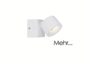 Ein Strahler namens Zog mit zylindrischem Design ist auf einem quadratischen Sockel montiert und wirft seitliches Licht. Der Strahler ist weiß, an der Wand montiert und auf der rechten Seite des Bildes erscheint das Wort „Mehr...“.