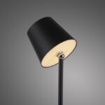 a black lamp with a white shade